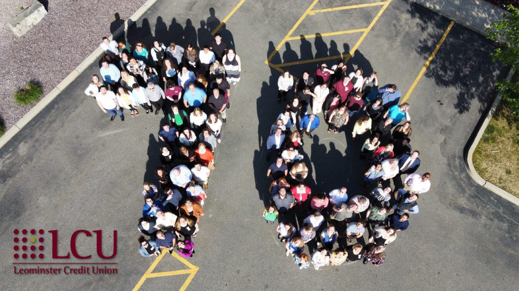 A photo of Team LCU outside, standing together as a large "7-0".